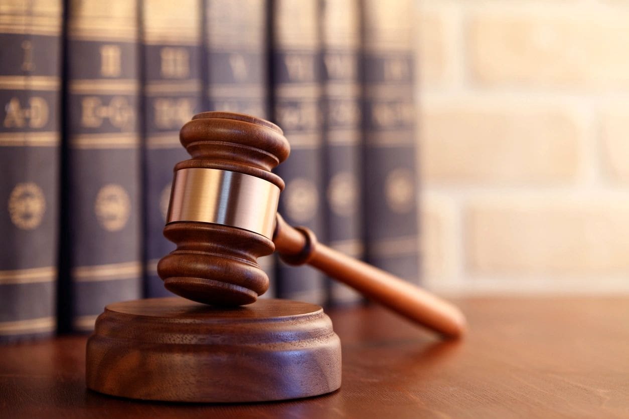 A wooden gavel sitting on top of a table.